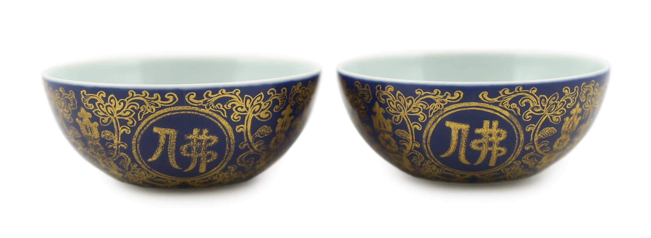 A pair of Chinese gilt decorated blue ground cups, Qianlong mark but later, one cracked